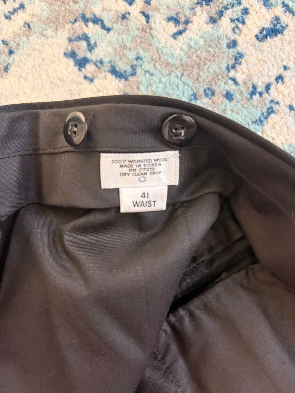 black Versini tuxedo jacket with a single-button closure and satin notch lapels.